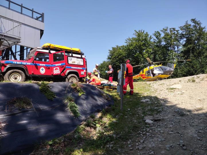 Ratownicy Grupy Podhalańskiej GOPR udzielają pomocy paralotniarzowi przed transportem śmigłowcem LPR (fot. Grupa Podhalańska GOPR, Facebook)