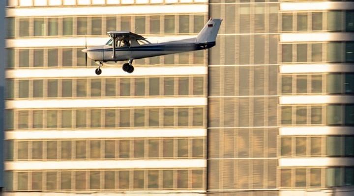 Cessna 152 w niskim przelocie nad miastem, fot. Skylineatlas